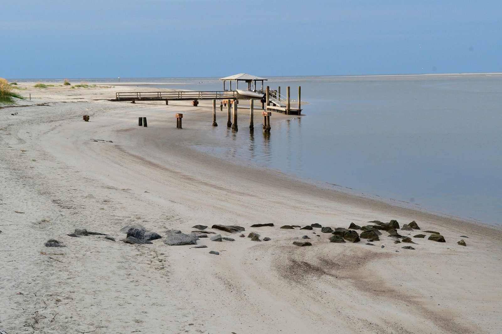 A sandy beach and floating dock at Tybee Island, Georgia